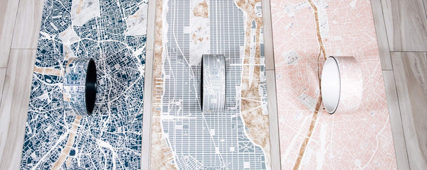 Three YOGASANA Urban Collection yoga mats and wheels inspired by city maps, capturing the textures and layered beauty of urban exploration