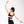 Woman wearing YOGASANA Aurora Ballerina Dual Tone Cross Back Sports Bra in black and pink, gracefully raising arm in dance pose.