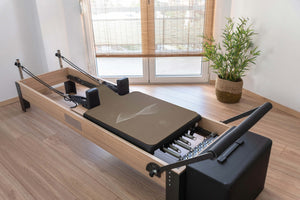 IMPETUS 2mm Pilates Reformer Mat - Desert Edition on wooden reformer machine by YOGASANA