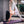 Yoga practitioner in white outfit doing one-legged downward dog pose on YOGASANA Glamorous Barcelona yoga mat.