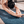 Close-up of woman stretching forward on Misty London yoga mat showing intricate London city map texture.