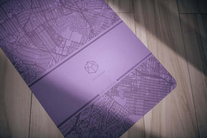 Detail shot of YOGASANA Urban Portrait Yoga Mat – Dusk Los Angeles, focusing on geometric YOGASANA logo and surface finish.