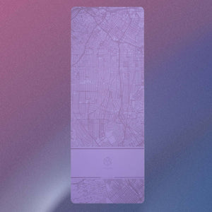 Overhead view of YOGASANA Urban Portrait 4mm Natural Rubber Yoga Mat – Dusk Los Angeles, showing full gradient design in lilac and dusk purple tones.