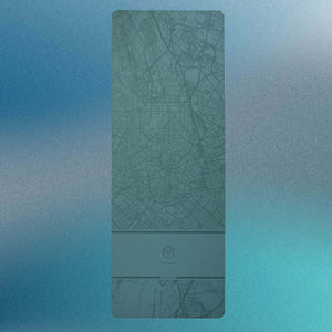 Flat lay top view of YOGASANA Urban Sketch Natural Rubber Yoga Mat in Renaissance Milan green with abstract map pattern.