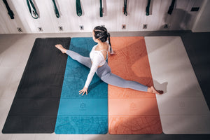 Woman doing splits on Yogasana 4mm yoga mats in four colours