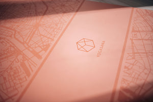 Close-up of Yogasana 4mm pink yoga mat with embossed logo