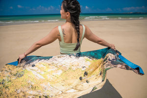 Back view of model holding Yogasana Island Garden double-sided yoga towel, inspired by Australian coastal textures.