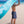 Yogasana Gradient Balance yoga towel lifted in the ocean breeze, revealing blue wave-inspired back design.