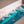 Close-up view of Yogasana Gradient Balance yoga towel surface with turquoise and sand-hued gradient texture.