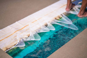 Close-up view of Yogasana Gradient Balance yoga towel surface with turquoise and sand-hued gradient texture.