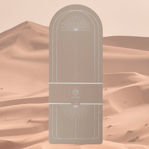 Flat lay of YOGASANA Lumiere Sundial 4mm Half-Round Natural Rubber Yoga Mat in Desert tone with silver alignment pattern, inspired by sunlit dunes and minimalist balance.
