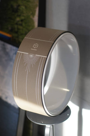 Lumiere Sundial Yoga Wheel – Dune (Silver Pattern Edition) displayed under natural light, highlighting its silver alignment lines and smooth curvature.