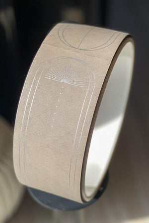Close-up view of Lumiere Sundial Yoga Wheel – Dune (Silver Pattern Edition), showcasing the refined silver sunburst pattern and soft matte PU texture.