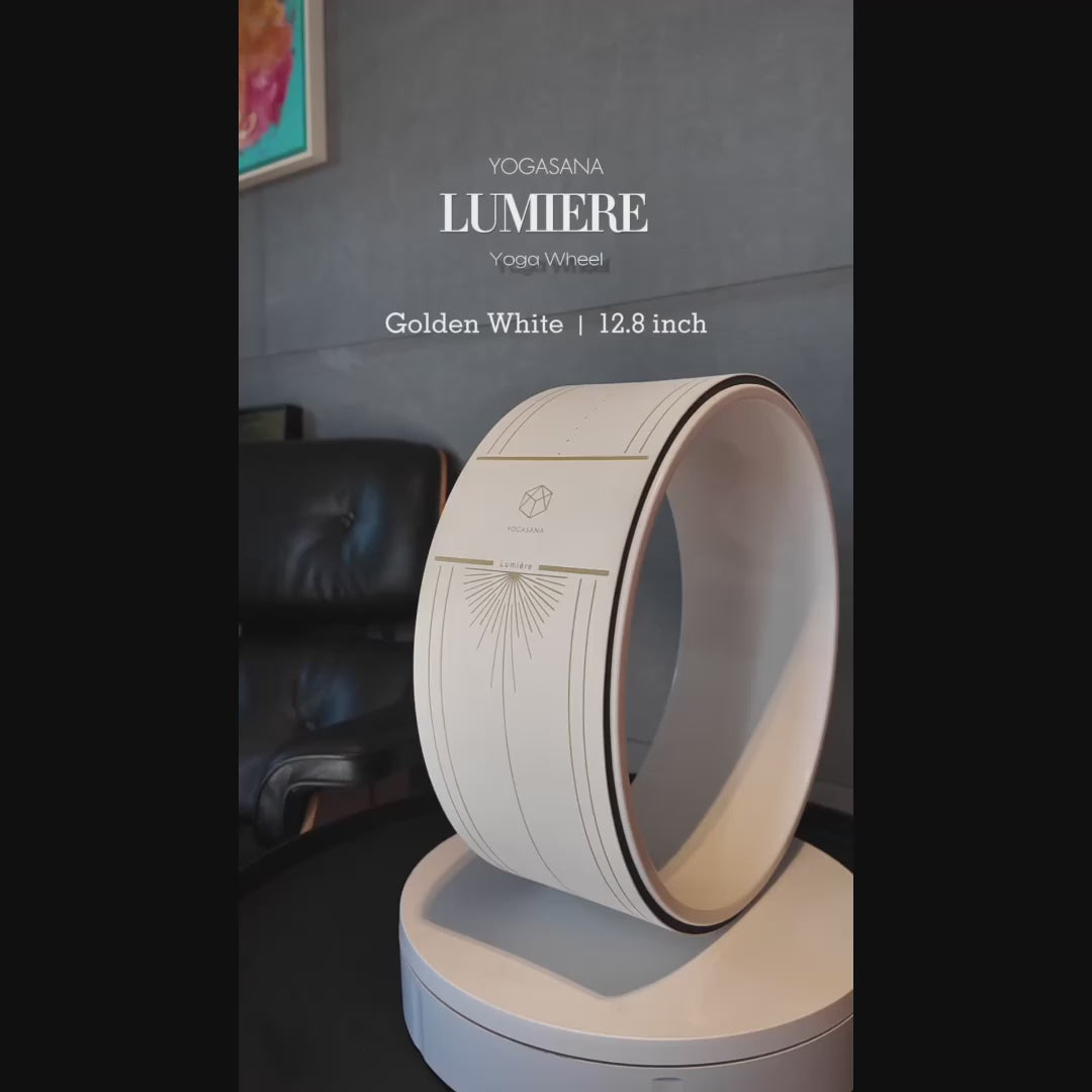 Rotating display of Lumiere Sundial Yoga Wheel – White (Golden Pattern Edition), showcasing its elegant gold detailing and premium design on a modern stand.