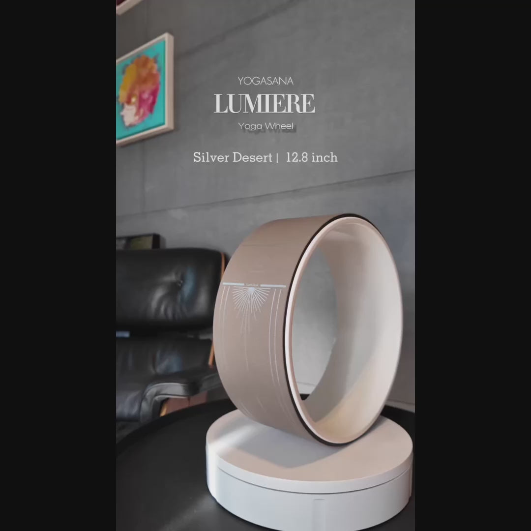 Rotating showcase of Lumiere Sundial Yoga Wheel – Dune (Silver Desert Edition), highlighting its elegant curvature and silver sunray pattern.