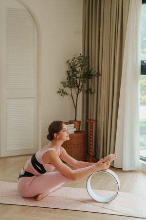 Yogasana Urban Portrait Daylight Paris yoga wheel supporting forward bend stretch for enhanced flexibility.