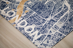 Close-up of Yogasana Urban Portrait Misty London yoga mat featuring detailed blue and gold London city map pattern.