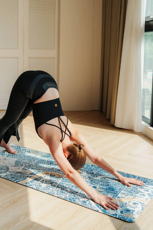 Yogasana Misty London city map yoga mat in use during downward dog pose, showing non-slip, soft-touch surface.