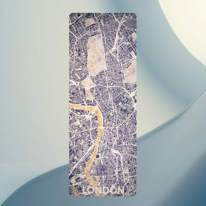 Yogasana Urban Portrait Misty London yoga mat flat lay, showing full London city map design in blue, marble, and gold tones.