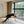 Model performing wild thing yoga pose on YOGASANA Urban Portrait 4mm Natural Rubber Yoga Mat – Misty London, showcasing stability and artistic design detail.