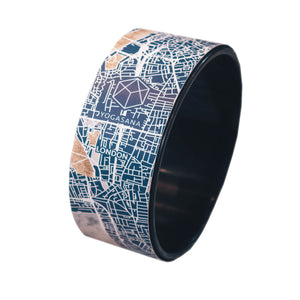 Front view of Yogasana Urban Portrait Yoga Wheel in Misty London design featuring navy city map pattern.