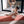 Yoga practitioner in white outfit performing boat pose on the Urban Sketch Yoga Mat – Daylight Paris, surrounded by natural light.