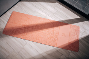 Close-up of the Urban Sketch Natural Rubber Yoga Mat – Daylight Paris, showcasing smooth texture and precise city map engraving.