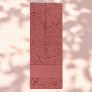 Flat lay of the Urban Sketch 4mm Natural Rubber Yoga Mat in Daylight Paris design, featuring a soft blush map print inspired by the city’s urban axis.