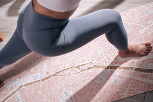 Close-up of woman practicing on YOGASANA Paris Map Yoga Mat, highlighting soft microfiber surface and strong non-slip grip.