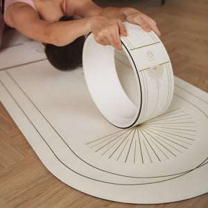 Yoga backbend pose using Yogasana Lumiere Sundial Yoga Wheel – White Golden edition on matching mat.