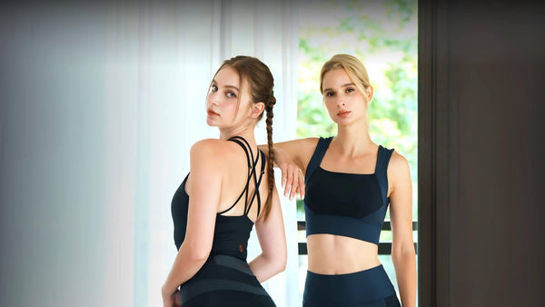 YOGASANA Self-Concept Collection Activewear — women in black yoga outfits standing by window (desktop banner)
